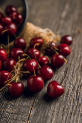 Ripe and juicy cherries on the dark rustic background. Selective focus. Shallow depth of field.