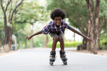 African American young boy riding on roller skates or roller blades at outdoor, Kid playing on...