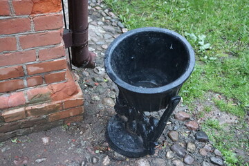 Obraz premium metal black trash can at street