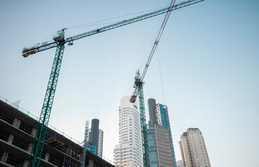 Fototapeta premium Construction of building with cranes