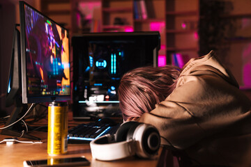 Image of exhausted girl sleeping on table while playing video game