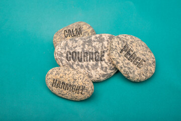 Text of calm, courage, harmony, peace on stone concept of meditation