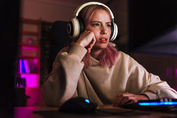 Image of confused charming girl playing video game on computer © Drobot Dean
