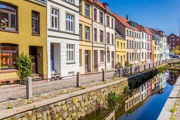 Fototapeta na wymiar Colorful houses with reflection in the canal in Wismar, Germany