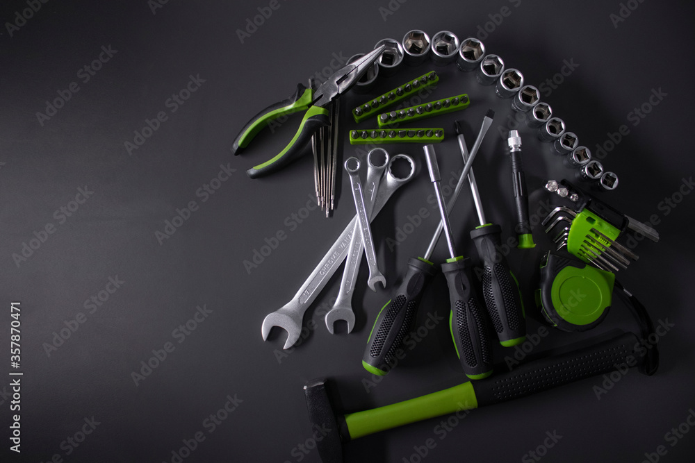 Wall mural A set of building tools and instruments for repair in black and green colour. Must-have for men. Equipment for building. Repair tool kit. construction concept. gray background . High quality photo