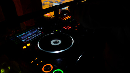 Defocused DJ spinning, mixing, and scratching in a night club. Night life and electronic music...