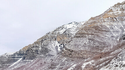 Panorama Provo Canyon mountain with steep rugged slopes dusted with snow in winter