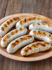 Grilled sausages on rustic plate