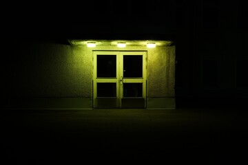 Green mental hospital door in the night.