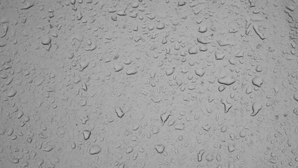 Rain weather wet car glass, dusty window with raindrops, rain water rain, backdrop drop texture background. Textured wet surface