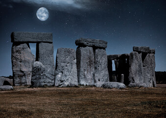 Stonehenge at night with a full moon and silvery blue light