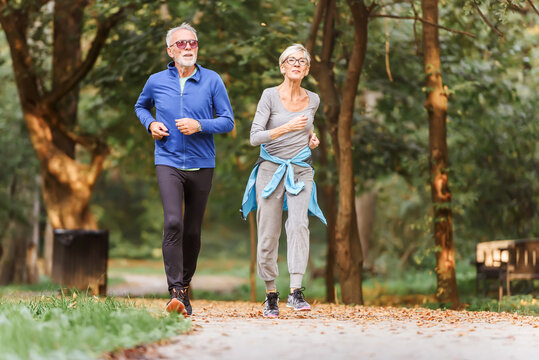 Smiling senior couple jogging in the park