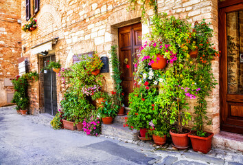 Fototapeta na wymiar Charming old medieval villages of Italy with typical floral narrow streets. Spello , Umbria