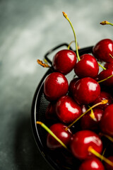 Ripe and juicy cherries on the dark rustic background. Selective focus. Shallow depth of field. 