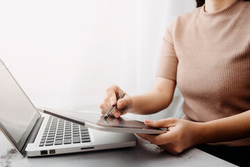 businesswoman hand using smart phone, tablet payments and holding credit card online shopping, omni channel, digital tablet docking keyboard computer at office in sun light