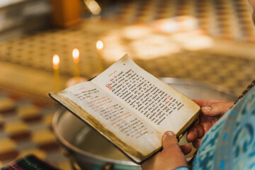 Priest reads pray. Holy book opened in priest hands in church. Orthodox faith. Equipment for praying. Pray for people life. Pray to god