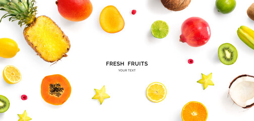 Creative layout made of pineapple, kiwi, lemon, lime, orange, papaya, coconut, pomegranate and carambola. Flat lay. Food concept.