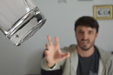 man throwing a glass