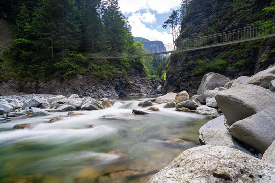 wooden suspension bridge crossing the Rhine River in the Viamala Gorge in the Swiss Alps