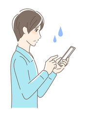 スマホを操作して不安な男性の横顔