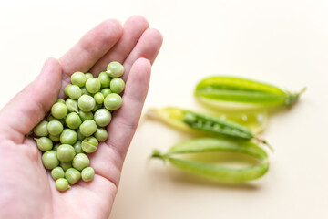 Fresh peas isolated on yelow background.Top view, selected focus.