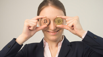 Fototapeta premium crazy bitcoin lover with golden coin by eyes; funny miner with btc near face