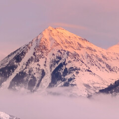 Fototapeta na wymiar Square frame Snowy Wasatch Mountains with sharp peaks illuminated by sunset in winter