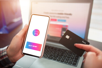 Closeup plan laptop smartphone and credit card in hands. Online shopping and home delivery concept.