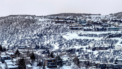 Panorama Mountain homes in Park City Utah with snowy nature landscape in winter