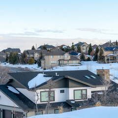Square Homes of snowed in town situated amid scenic terrain of Wasatch Mountains