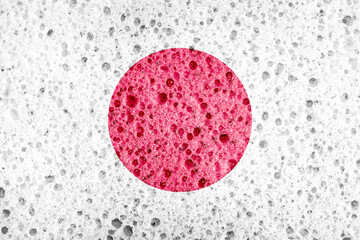 Japan flag on sponge texture.