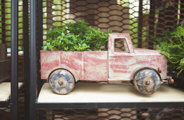 Vintage toy car pot with a plant inside