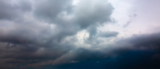 Naklejka na ściany i meble Grey sky with rainy clouds. Dramatic nature.