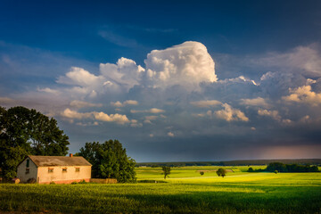 storm clouds over the field and village