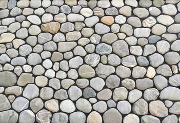 Wall or fence texture with pebble stones