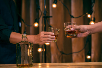 Barman pouring whiskey glass celebrate whiskey on a friendly party in  restaurant