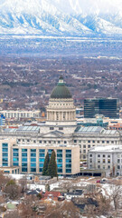 Vertical frame Utah State Capitol Building against a sweeping view of Salt Lake City in winter