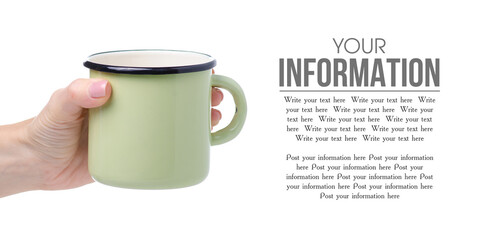 Green enamel cup in hand on white background isolation, copy space