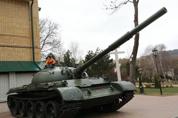 Boy playing on Soviet main battle tank T-62