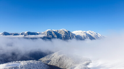 Fototapeta na wymiar Romania, Baiului Mountains, viewpoint to Bucegi Mountains, snow covered mountains