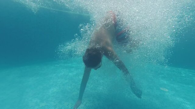 Underwater boy portrait in swimming pool