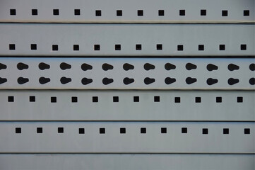 Close-up sectional full frame view of a stack of heavy metal shelves stored behind a warehouse