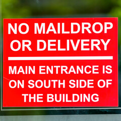 Square frame Close up of red No Maildrop Or Delivery sign on the glass wall of a building