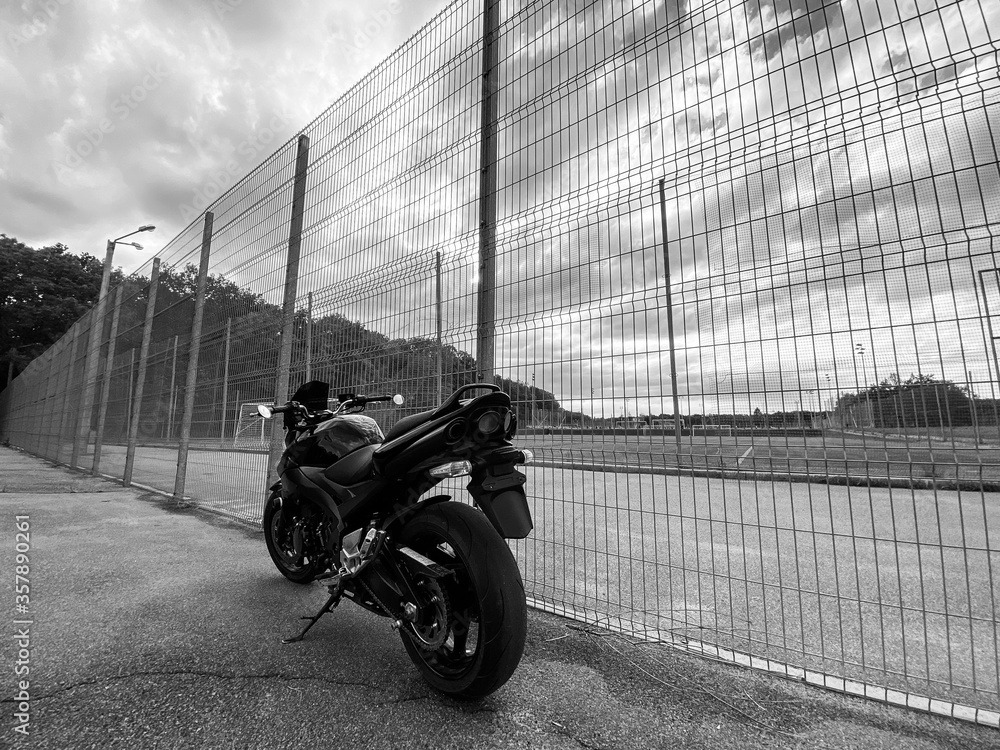 Wall mural Black motorcycle close-up on the street.