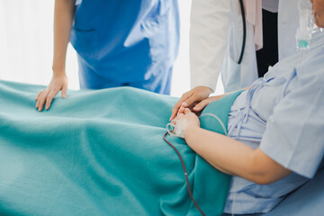 Obraz premium Hand of Young Asian woman doctor and nurse giving advice discussion and check up to elderly patient sitting in bed at hospital which smiling and felling happy. Medicine and health care safe concept.