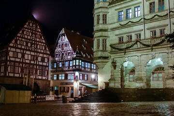 Traditional half-timbered houses on narrow medieval street in Rothenburg ob der Tauber, Bavaria,...