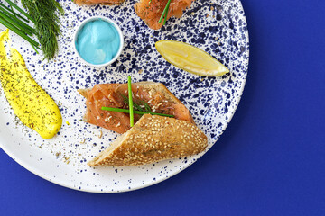 Norwegian smoked salmon canapes with lemon, blue cheese sauce, pepper and salt from above