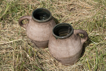 Clay mugs jugs on the grass