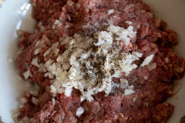 minced in a food processor. Minced meat in a container with onions. Stuffed meat with chopped onions