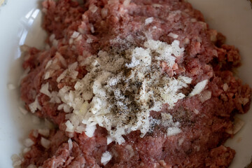minced in a food processor. Minced meat in a container with onions. Stuffed meat with chopped onions